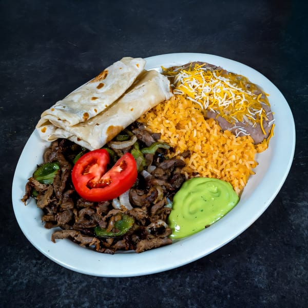 A Highlands D'Leon's Mexican dish with steak, rice, beans, tortillas, tomato, and green sauce.