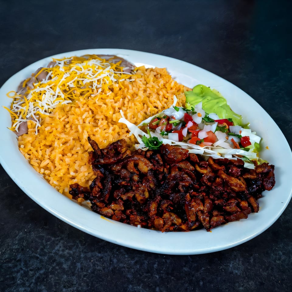 A Highlands D'Leon's Mexican dish with grilled meat, rice, beans, and fresh pico de gallo.